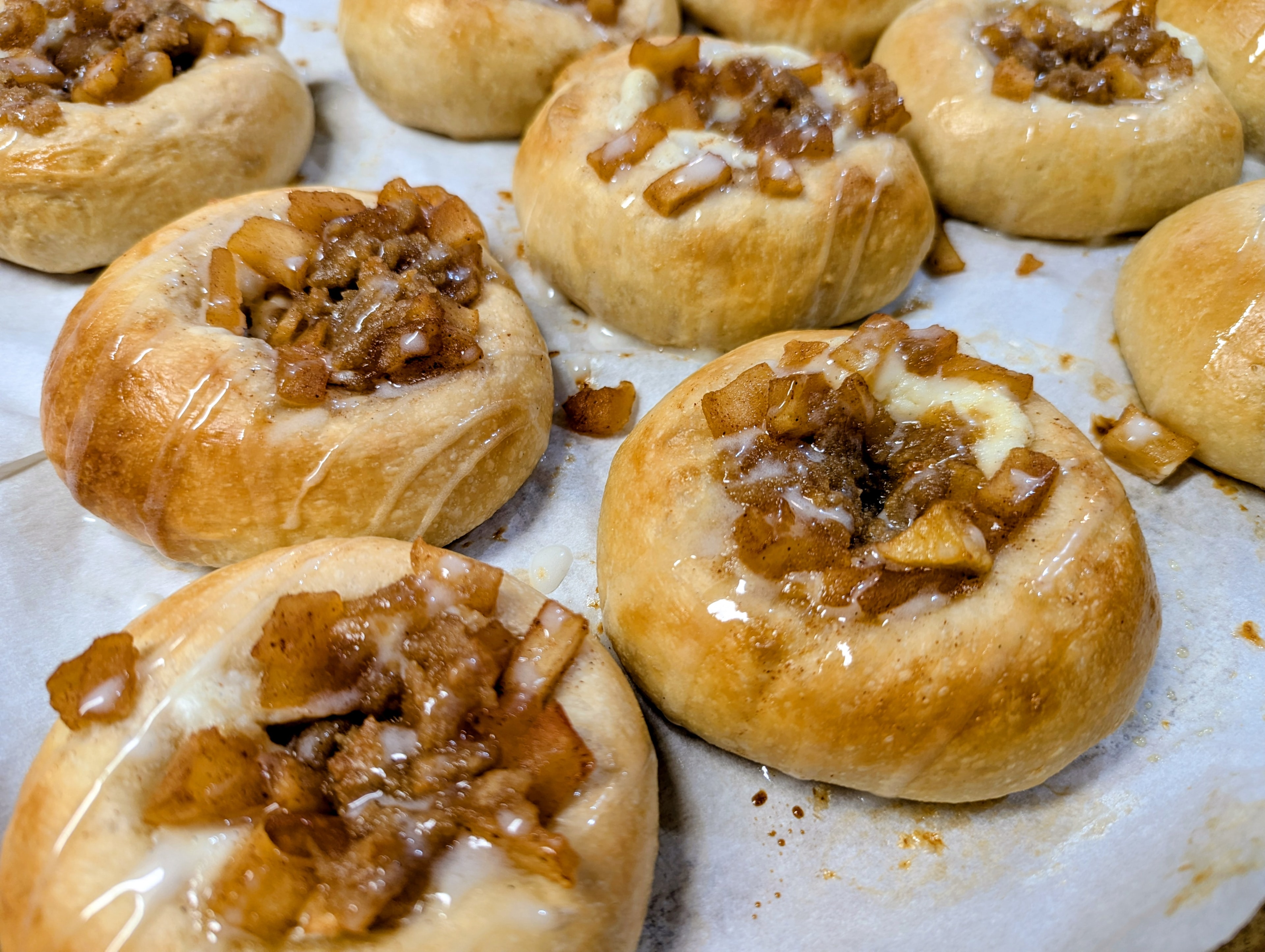 Apple pie brioche tarts with caramel and pecan filling on parchment