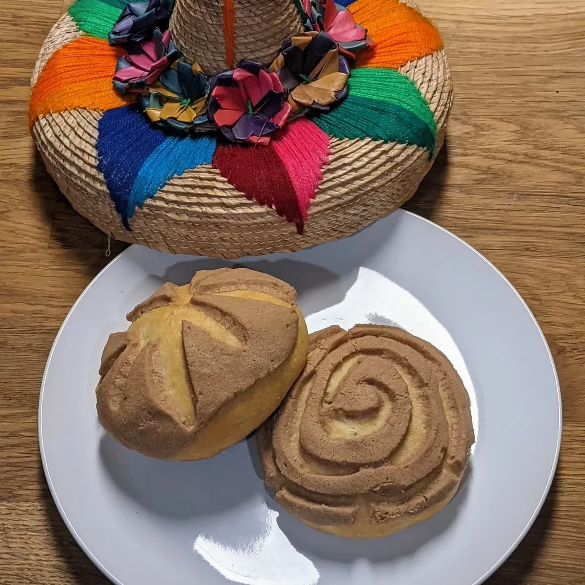 Pan dulce pastries on a plate with a decorative woven basket