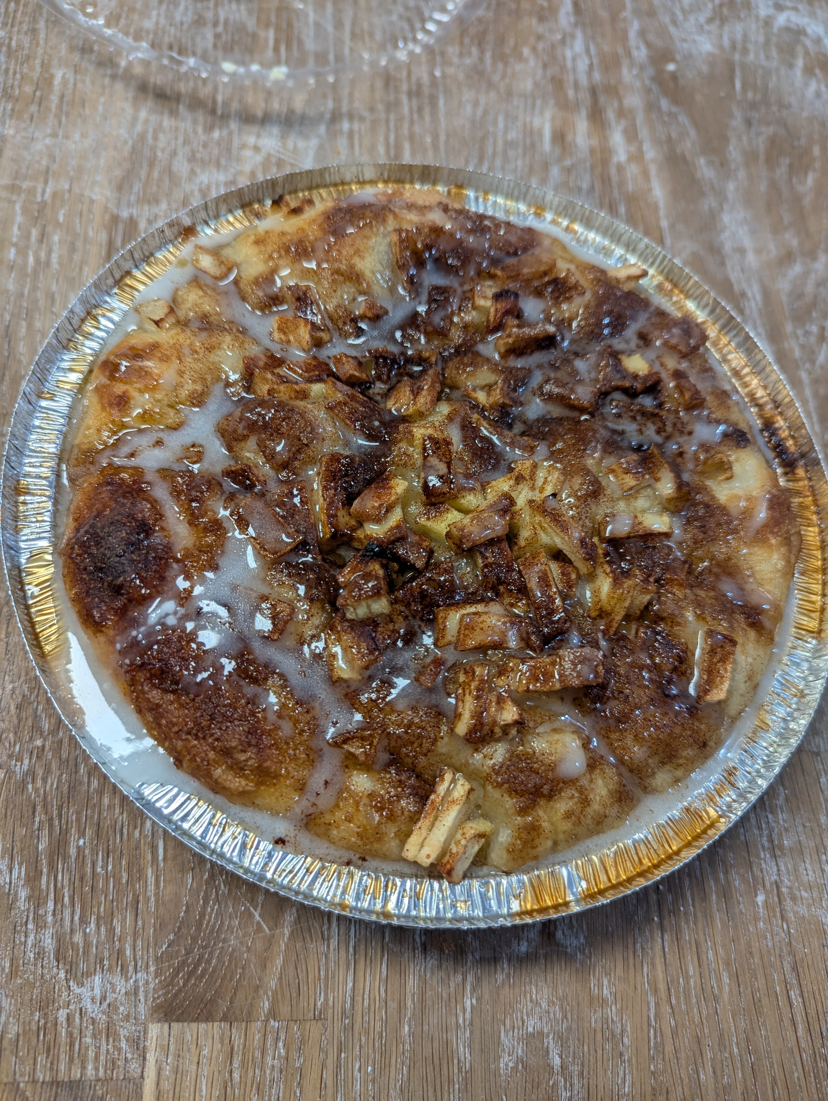 Apple pie focaccia with cinnamon glaze in a foil pan